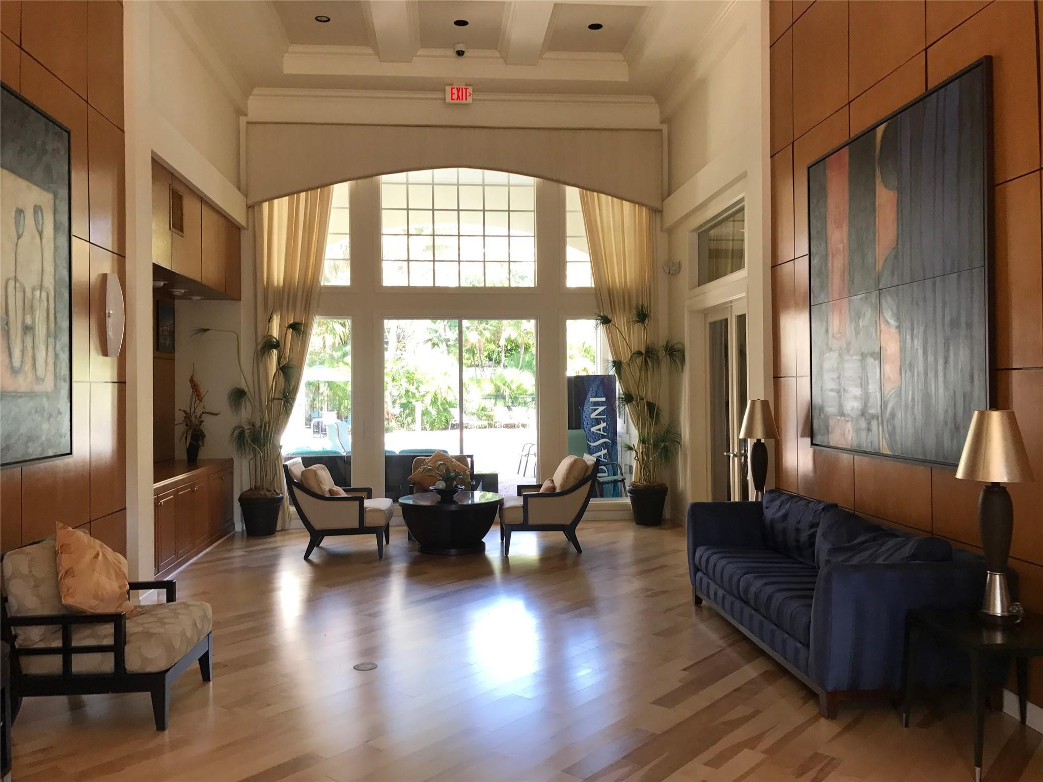 5800 West Sample Road, Unit 305 Coral Springs, FL 33067 - Photo 23 of 28 a living room with furniture and a large window