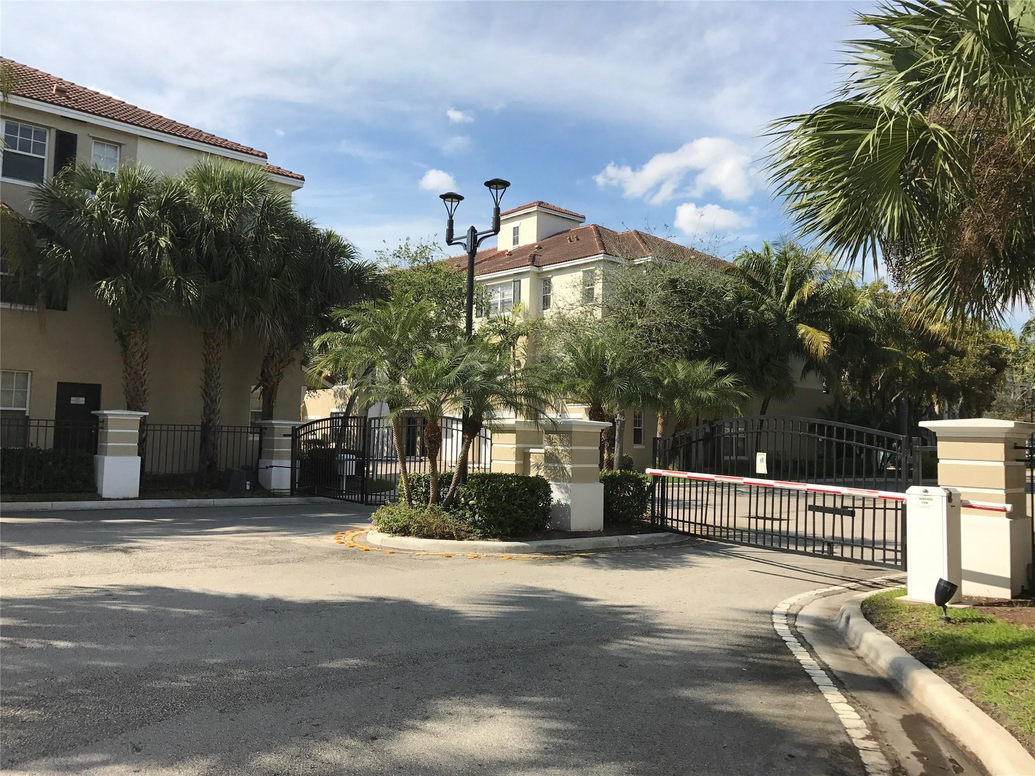 5800 West Sample Road, Unit 305 Coral Springs, FL 33067 - Photo 26 of 28 a front view of a house with a yard