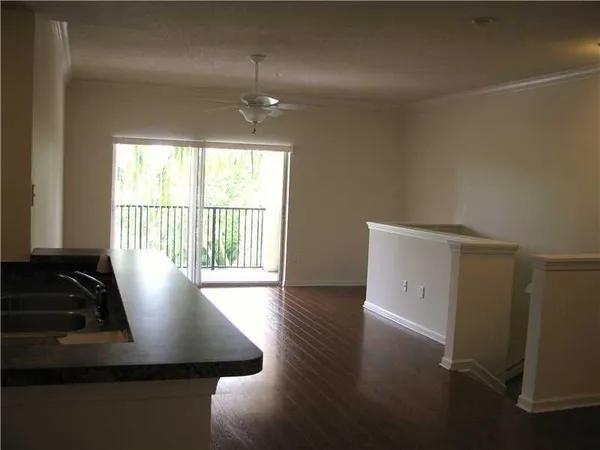 a view of a room with wooden floor and a window