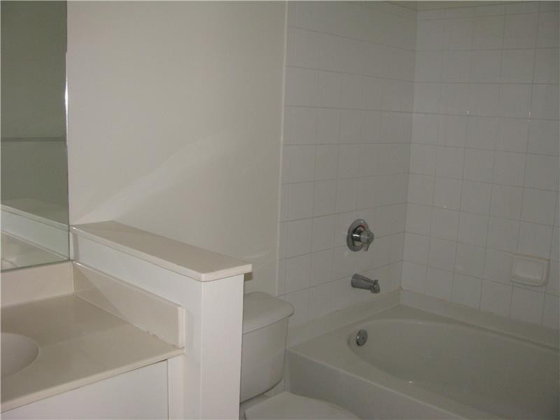 5800 West Sample Road, Unit 305 Coral Springs, FL 33067 - Photo 7 of 28 a bathroom with a bathtub