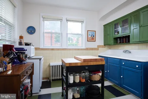a room with a table chairs and a window