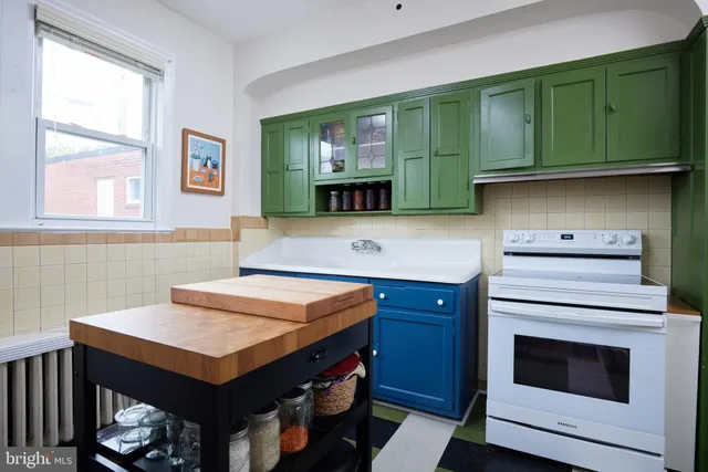 a kitchen with cabinets and window