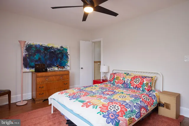 a bedroom with a bed and a dresser in it