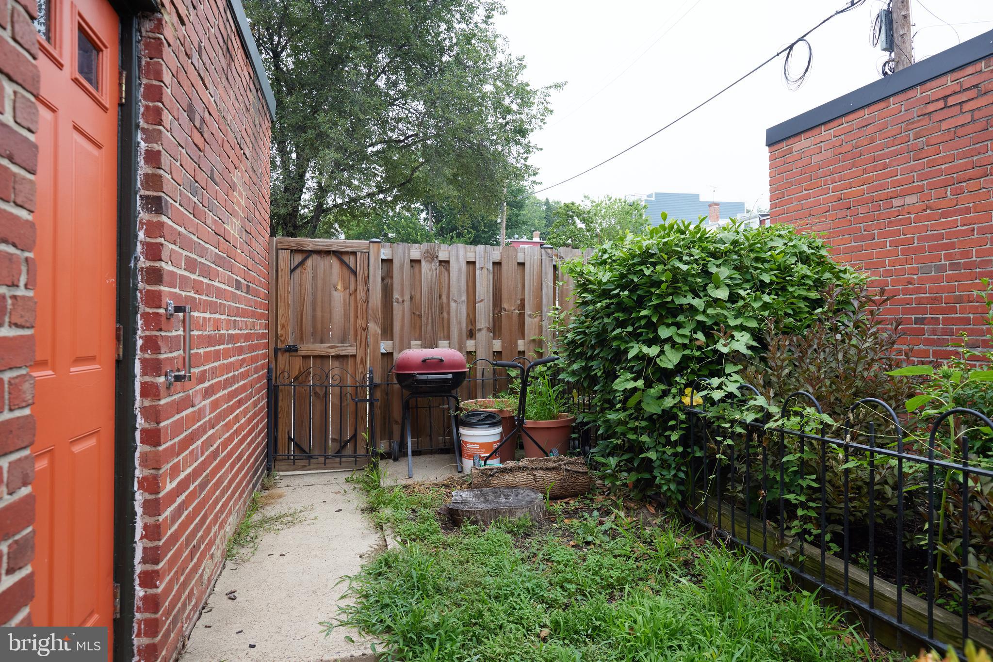5417 4th Street Northwest Washington, DC 20011 - Photo 24 of 29 a view of a patio with table and chairs potted plants and wooden fence