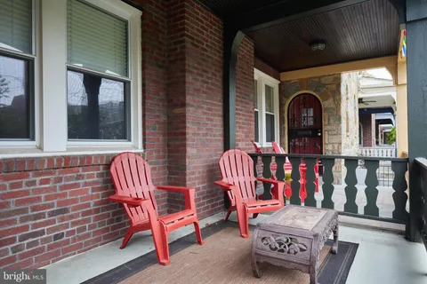 a view of a chairs and table in back of the house