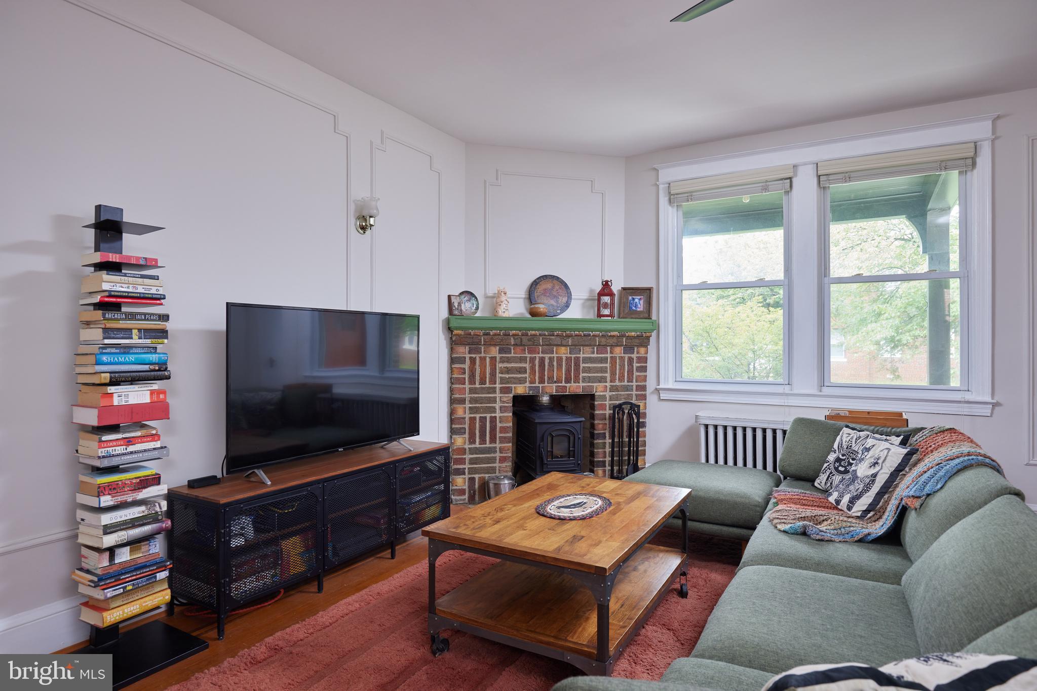 5417 4th Street Northwest Washington, DC 20011 - Photo 5 of 29 a living room with furniture a flat screen tv and a fireplace