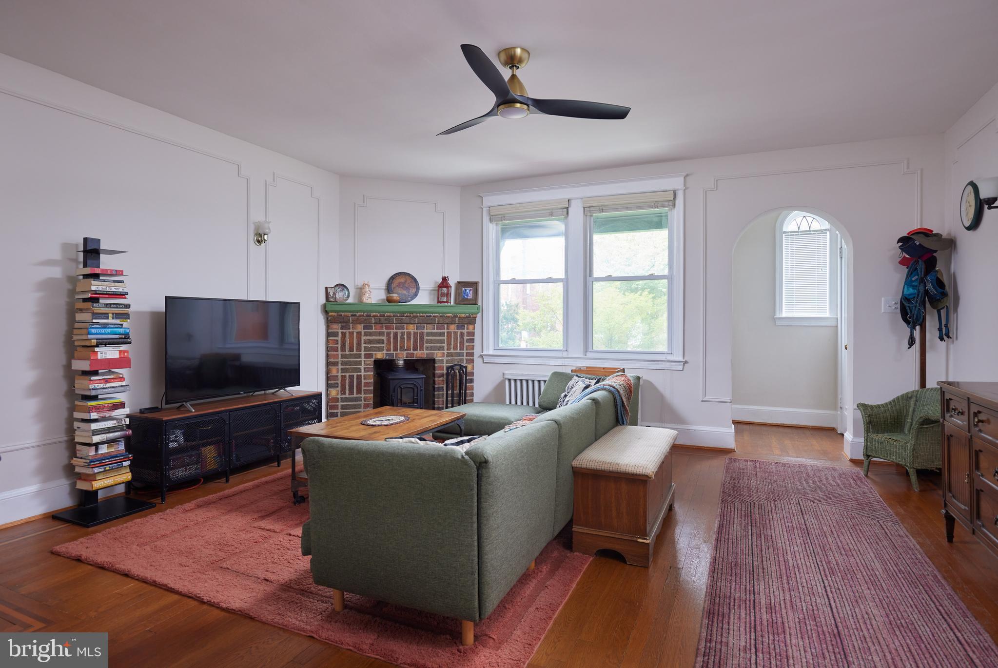 5417 4th Street Northwest Washington, DC 20011 - Photo 7 of 29 a living room with furniture a flat screen tv and a fireplace