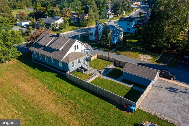 an aerial view of a house with yard swimming pool and outdoor seating