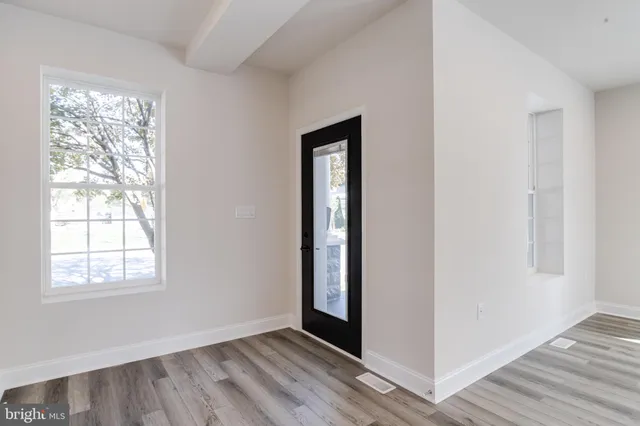 a view of a kitchen with a sink and a refrigerator