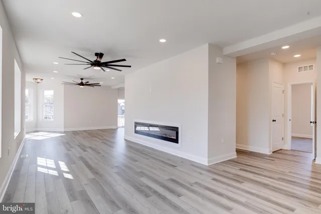 a kitchen with a sink a refrigerator and a stove top oven
