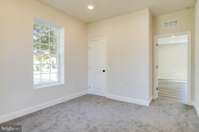 a bathroom with a sink a toilet and a window