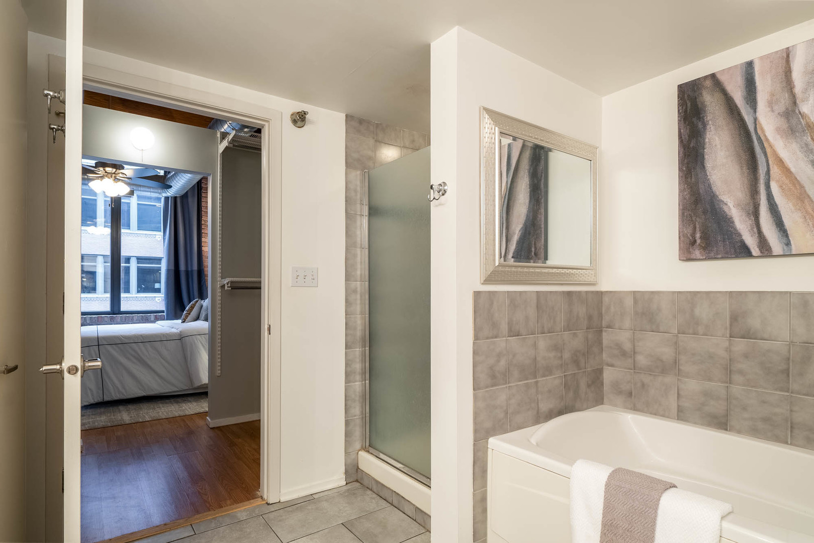 625 West Jackson Boulevard, Unit 313 Chicago, IL 60661 - Photo 12 of 33 a bathroom with a tub and a shower
