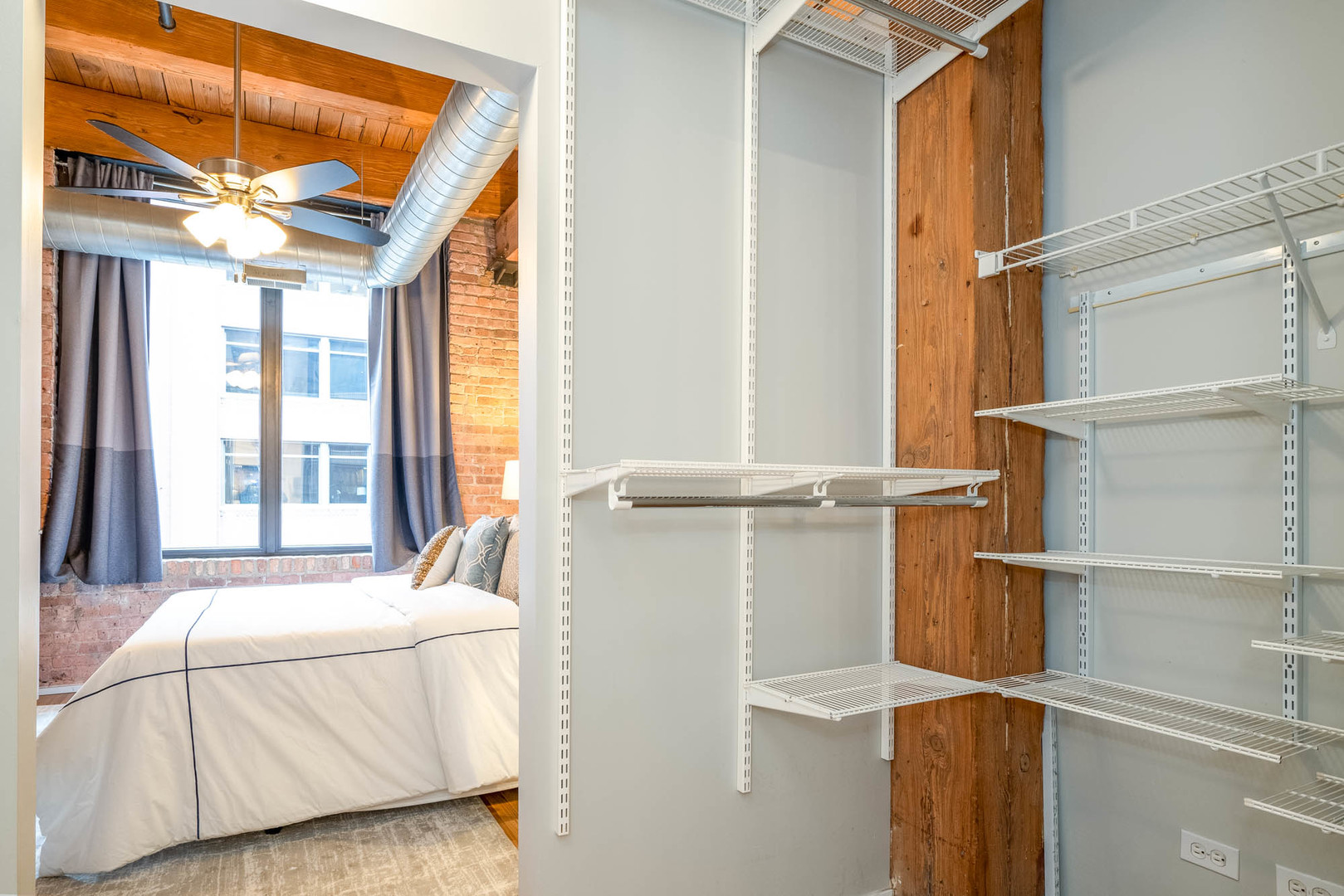 625 West Jackson Boulevard, Unit 313 Chicago, IL 60661 - Photo 13 of 33 a bed room with a bed and a window