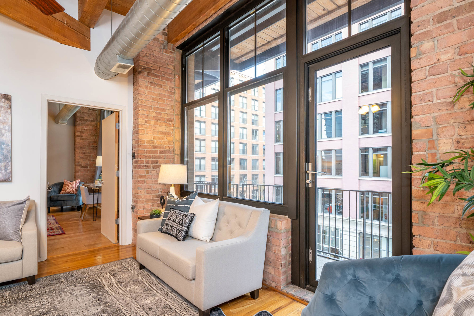 625 West Jackson Boulevard, Unit 313 Chicago, IL 60661 - Photo 14 of 33 a living room with furniture and a large window