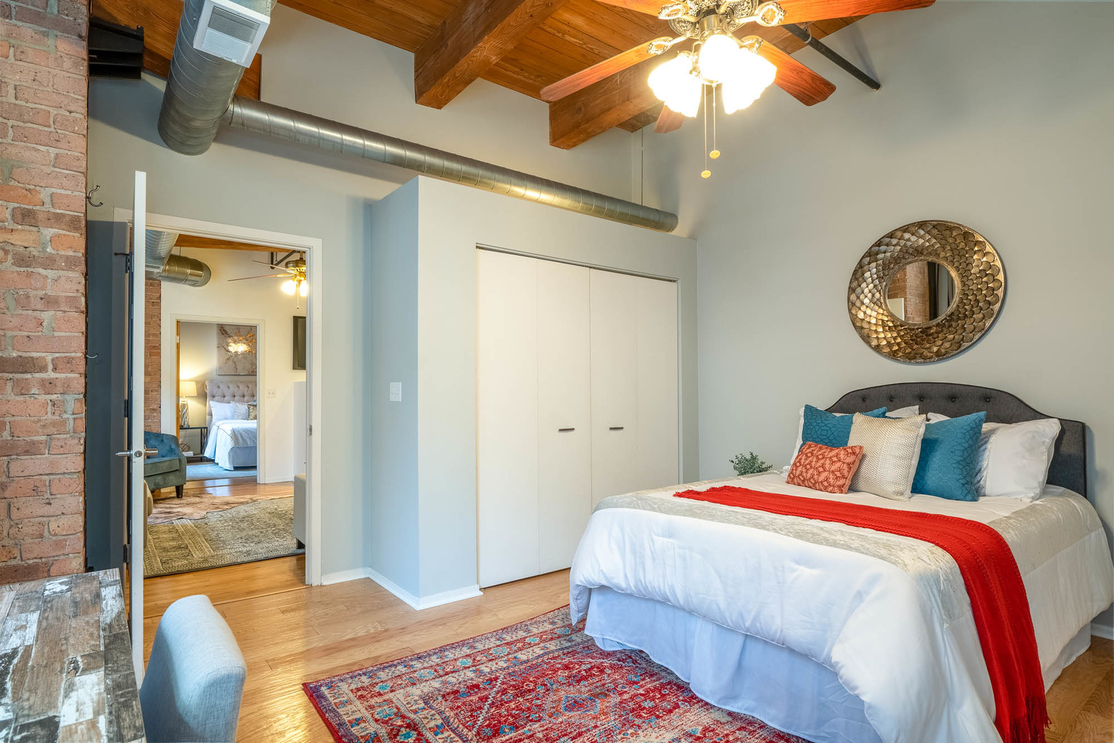 625 West Jackson Boulevard, Unit 313 Chicago, IL 60661 - Photo 21 of 33 a bedroom with a bed and a chandelier