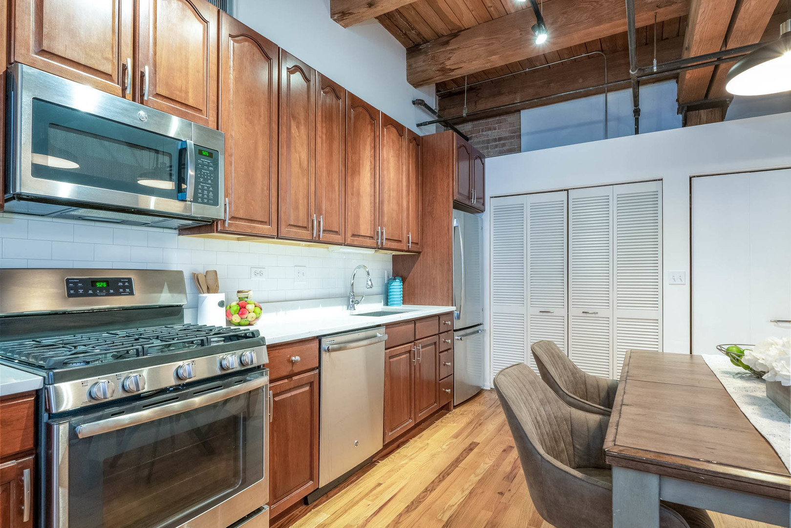 625 West Jackson Boulevard, Unit 313 Chicago, IL 60661 - Photo 24 of 33 a kitchen with stainless steel appliances granite countertop a stove a sink and a microwave