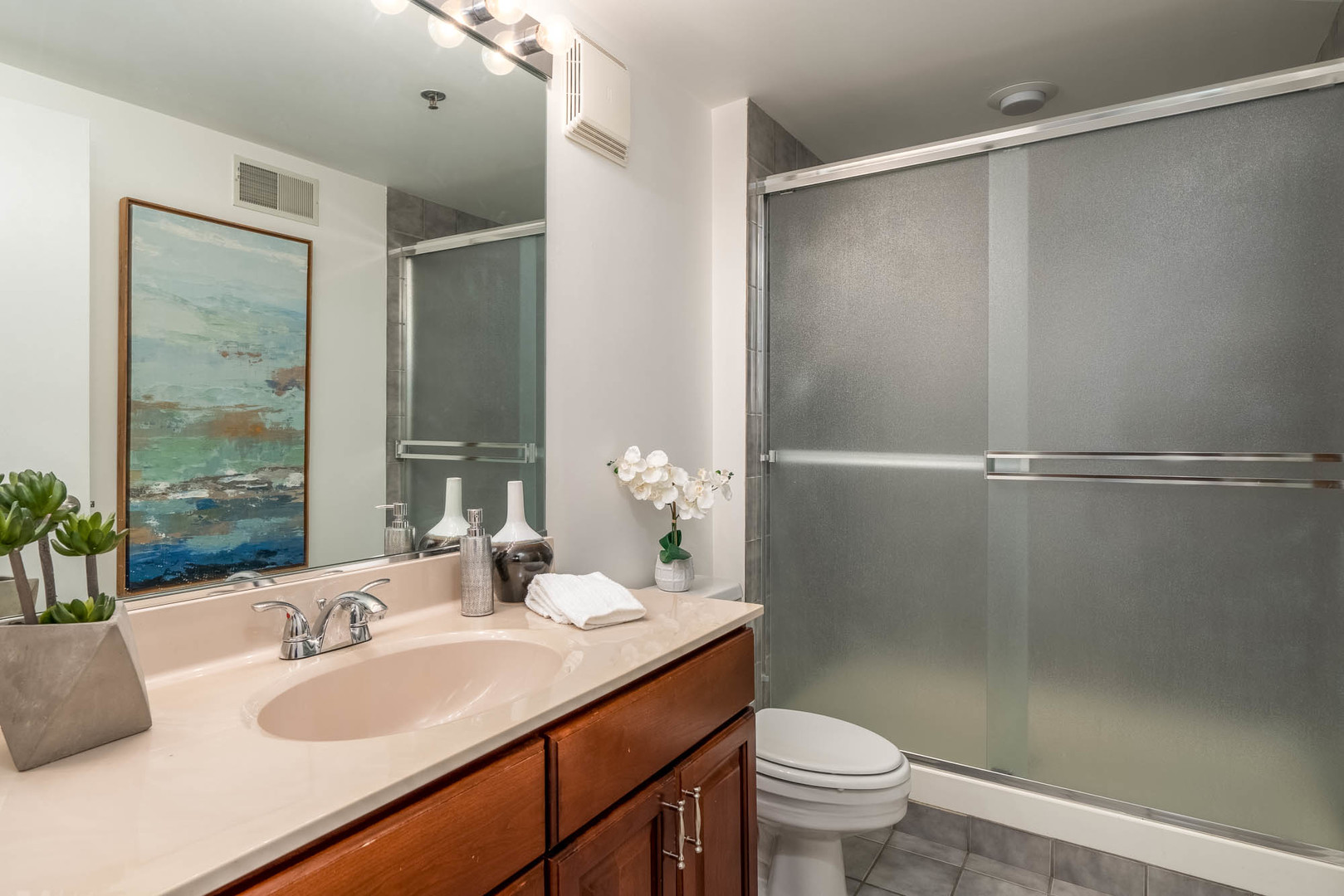 625 West Jackson Boulevard, Unit 313 Chicago, IL 60661 - Photo 27 of 33 a bathroom with a granite countertop sink toilet and shower