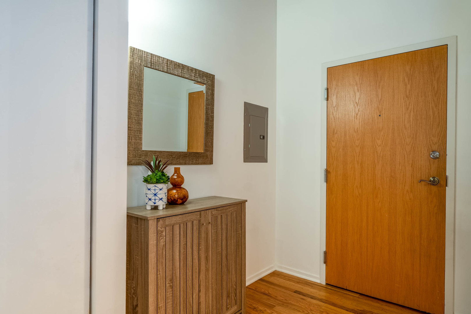 625 West Jackson Boulevard, Unit 313 Chicago, IL 60661 - Photo 28 of 33 a bedroom with a bed and a wooden floor