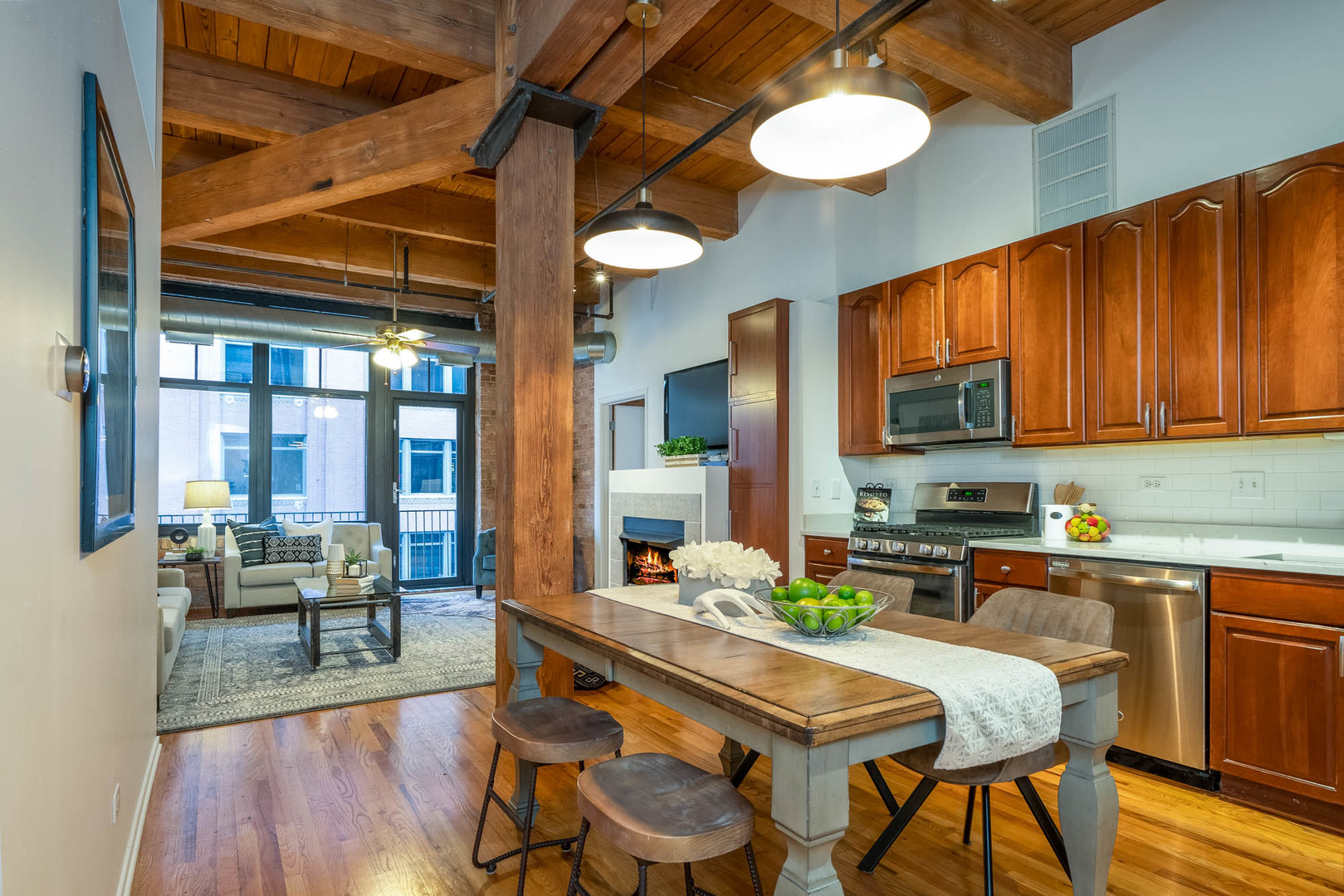 625 West Jackson Boulevard, Unit 313 Chicago, IL 60661 - Photo 29 of 33 a kitchen with a table chairs stove and cabinets