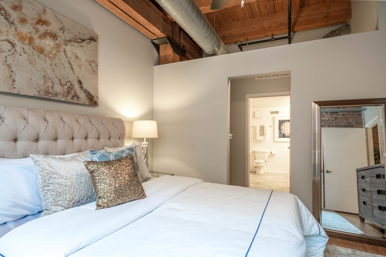 625 West Jackson Boulevard, Unit 313 Chicago, IL 60661 - Photo 8 of 33 a bedroom with a bed and a couch