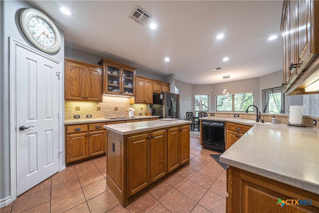 519 Long Meadow Spring Branch, TX 78070 - Photo 9 of 33 a kitchen with a stove a sink and a refrigerator