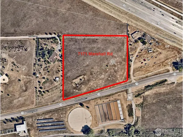 a view of a garden with a building in the background