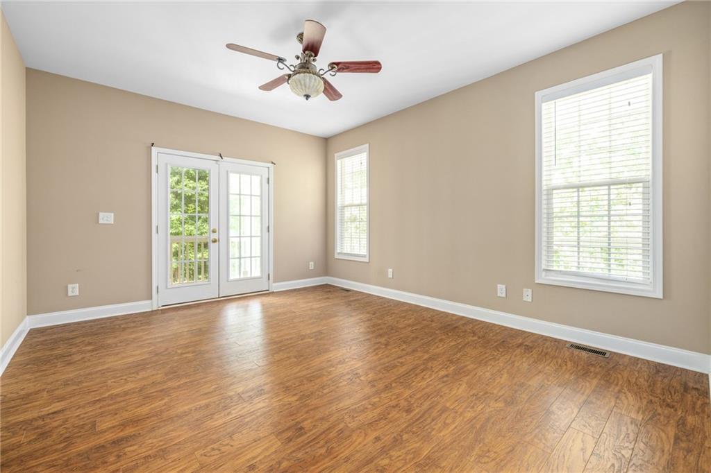 7913 Pea Ridge Road Lula, GA 30554 - Photo 14 of 51 a view of an empty room with a window and wooden floor
