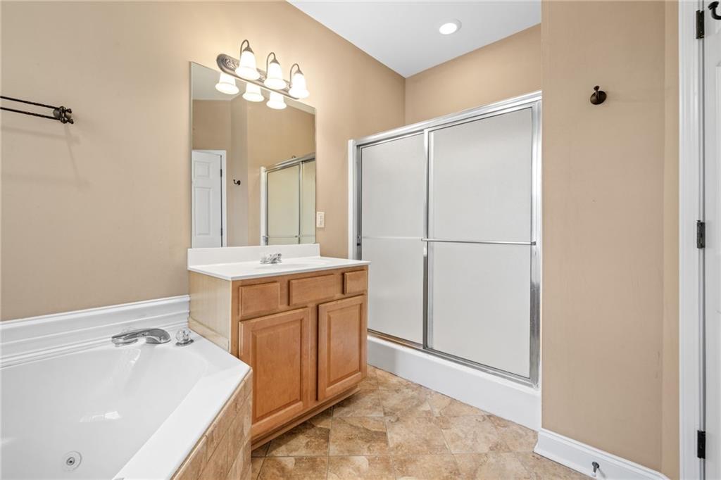 7913 Pea Ridge Road Lula, GA 30554 - Photo 17 of 51 a bathroom with a tub sink and mirror
