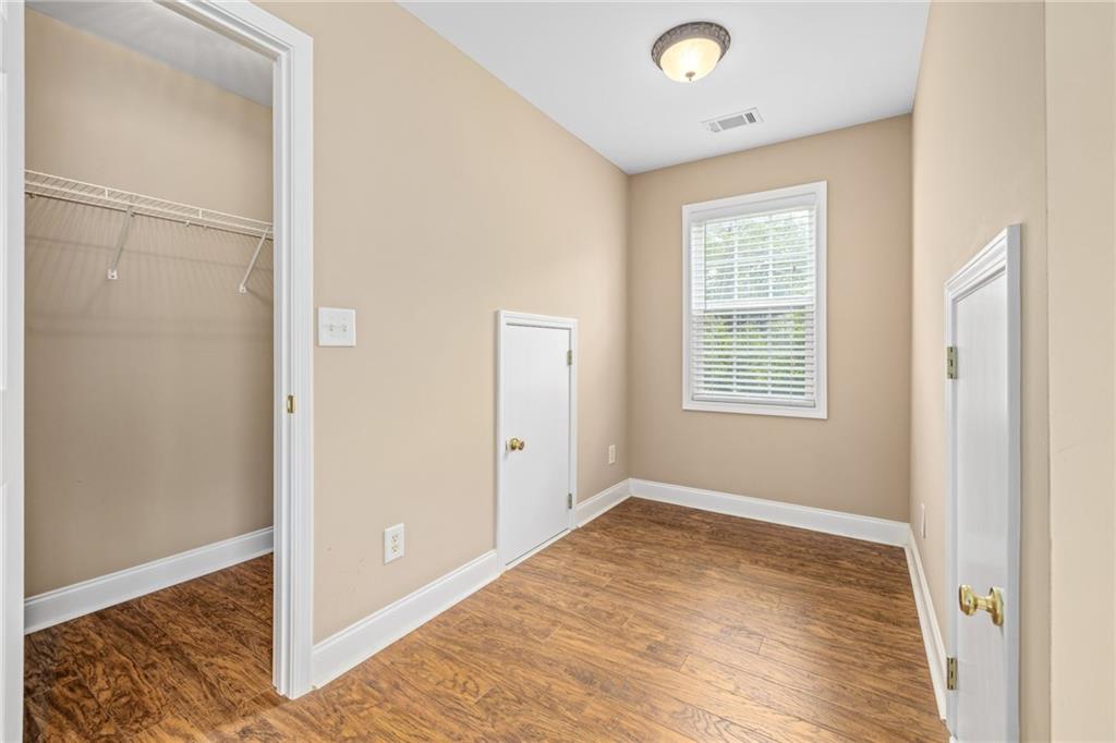 7913 Pea Ridge Road Lula, GA 30554 - Photo 26 of 51 a view of an empty room with wooden floor and a window