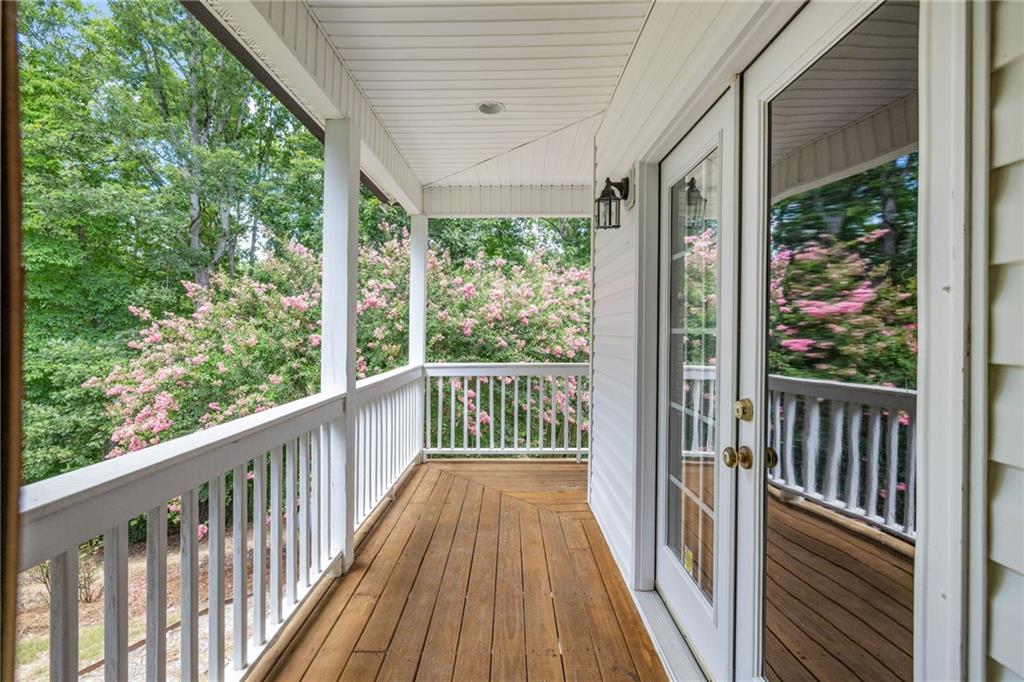 7913 Pea Ridge Road Lula, GA 30554 - Photo 30 of 51 a view of a porch with wooden floor in front of a house