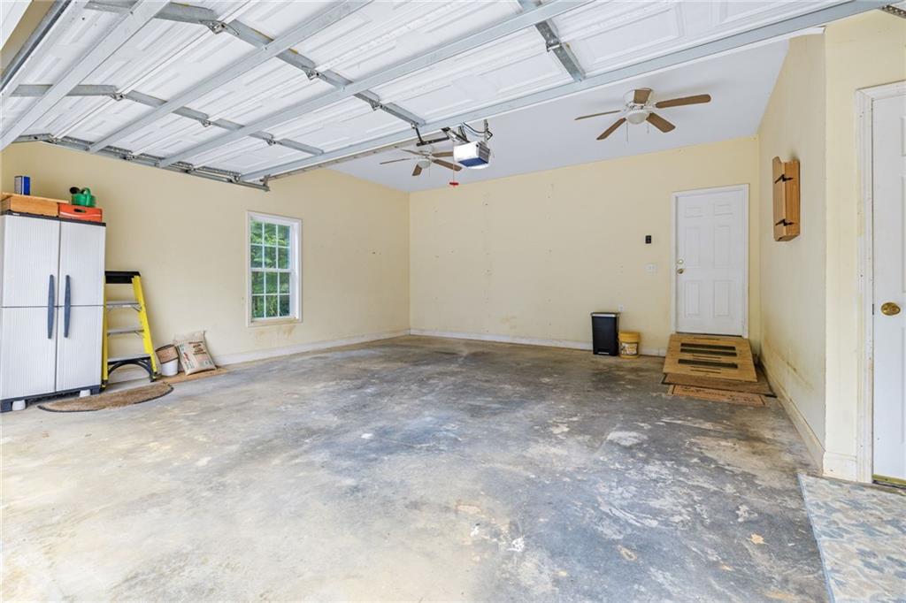 7913 Pea Ridge Road Lula, GA 30554 - Photo 35 of 51 en empty room with windows and ceiling fan