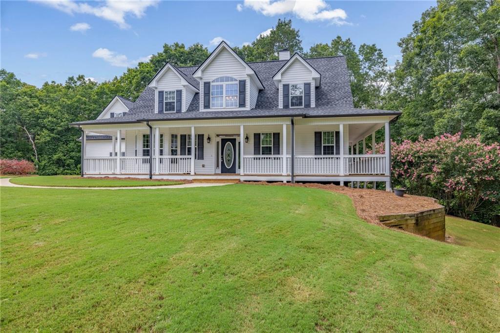 7913 Pea Ridge Road Lula, GA 30554 - Photo 45 of 51 a front view of a house with a yard table and chairs