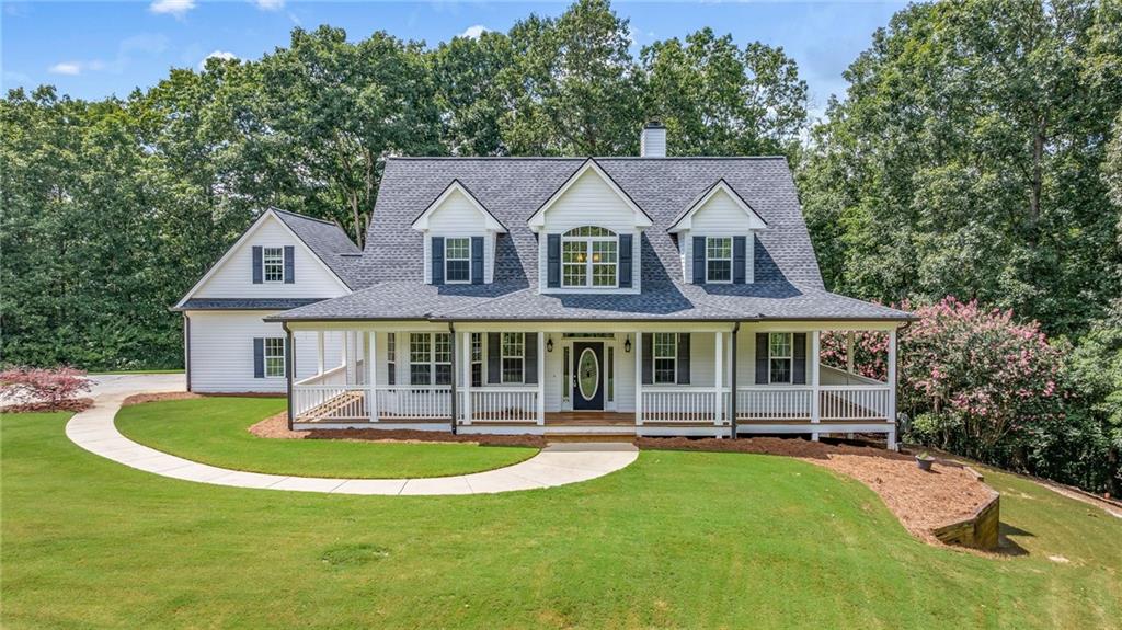 7913 Pea Ridge Road Lula, GA 30554 - Photo 47 of 51 a front view of a house with a yard table and chairs