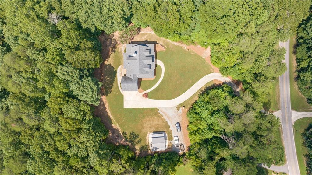 7913 Pea Ridge Road Lula, GA 30554 - Photo 48 of 51 an aerial view of a house with a swimming pool and garden