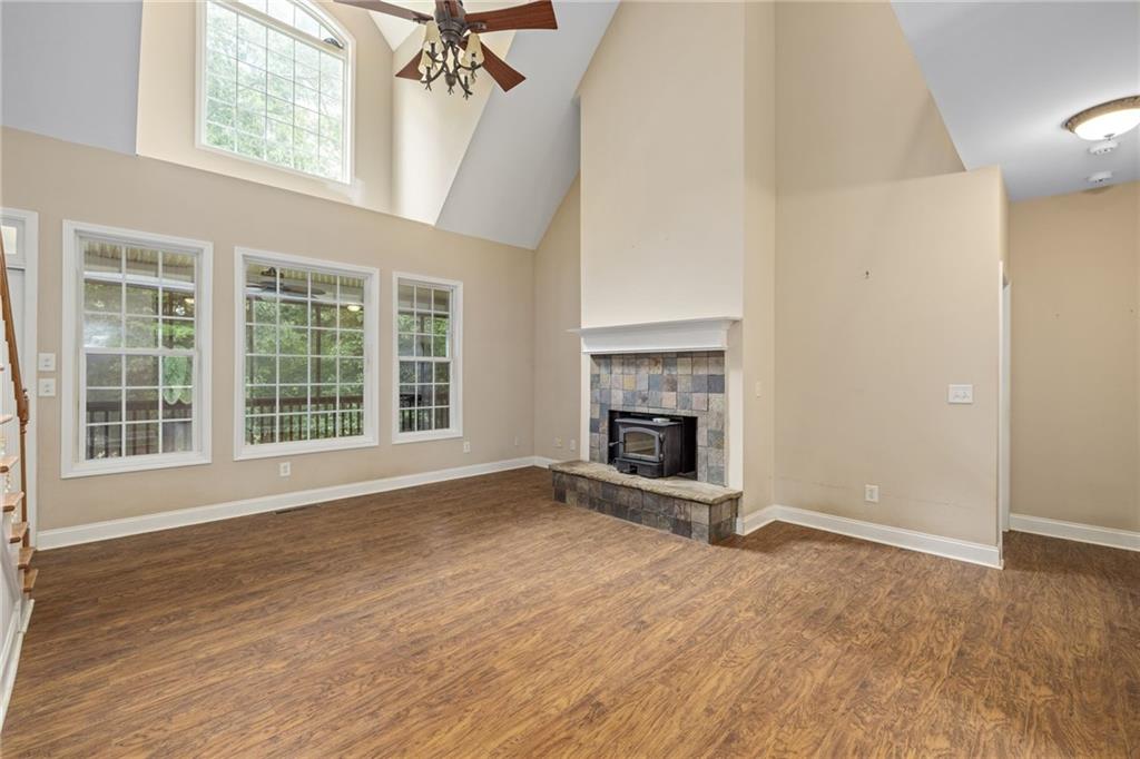 7913 Pea Ridge Road Lula, GA 30554 - Photo 6 of 51 a view of an empty room with a fireplace and a window
