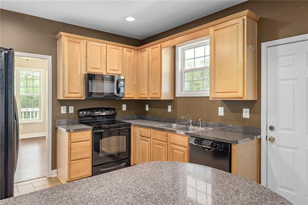 7913 Pea Ridge Road Lula, GA 30554 - Photo 10 of 51 a kitchen with stainless steel appliances granite countertop a stove a sink and a microwave