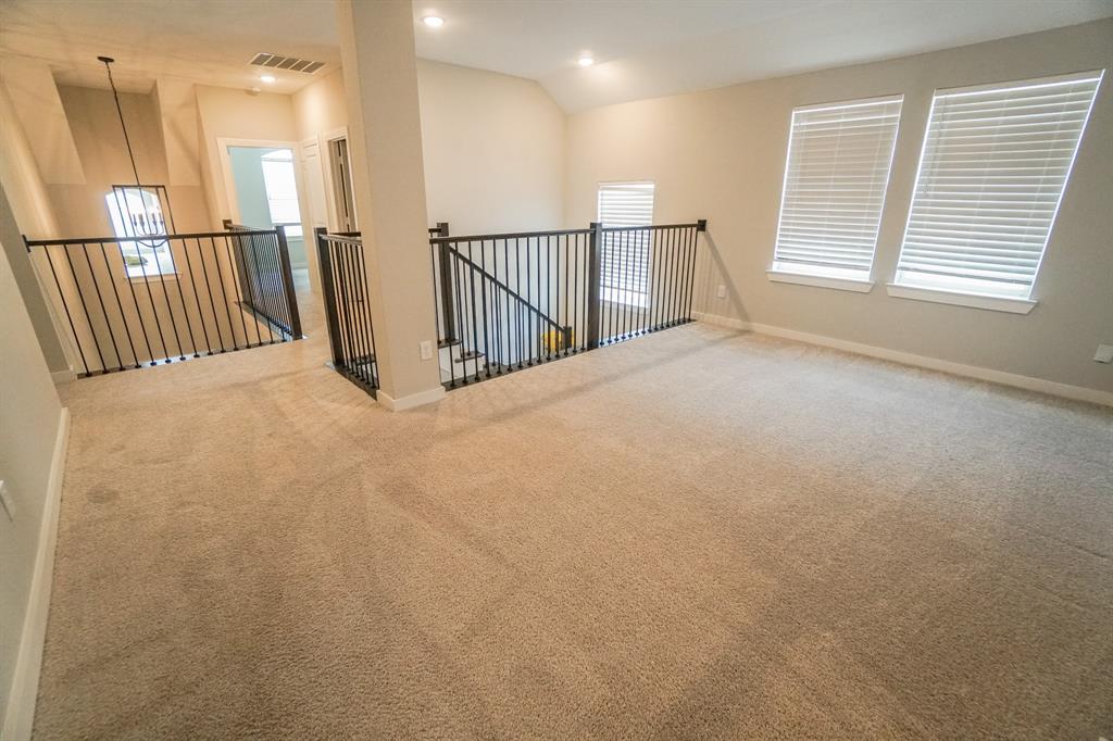 1309 Old Rocksprings Pass Mansfield, TX 76063 - Photo 19 of 36 Open loft area featuring neutral-toned carpeting and light gray wall paint
