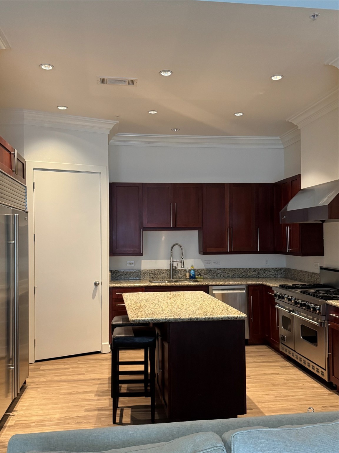 3388 Sage Road, Unit 101 Houston, TX 77056 - Photo 21 of 32 a kitchen with stainless steel appliances granite countertop a stove a sink and a refrigerator