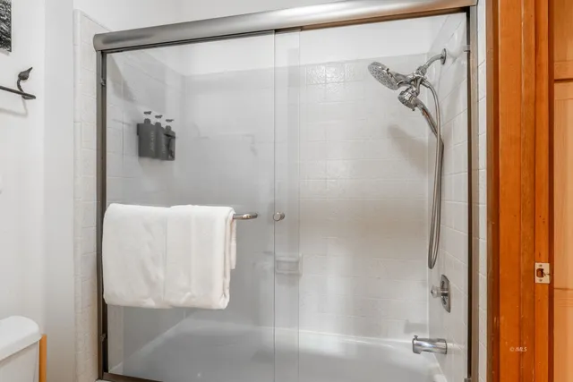 a bathroom with a glass shower door