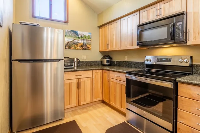 a kitchen with a refrigerator stove and microwave