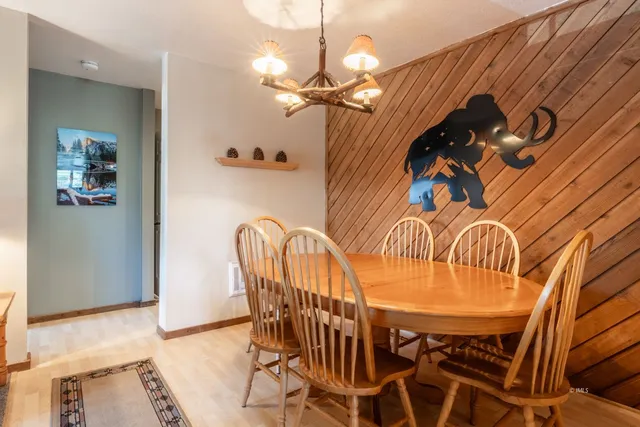 a dining room with furniture and a mirror