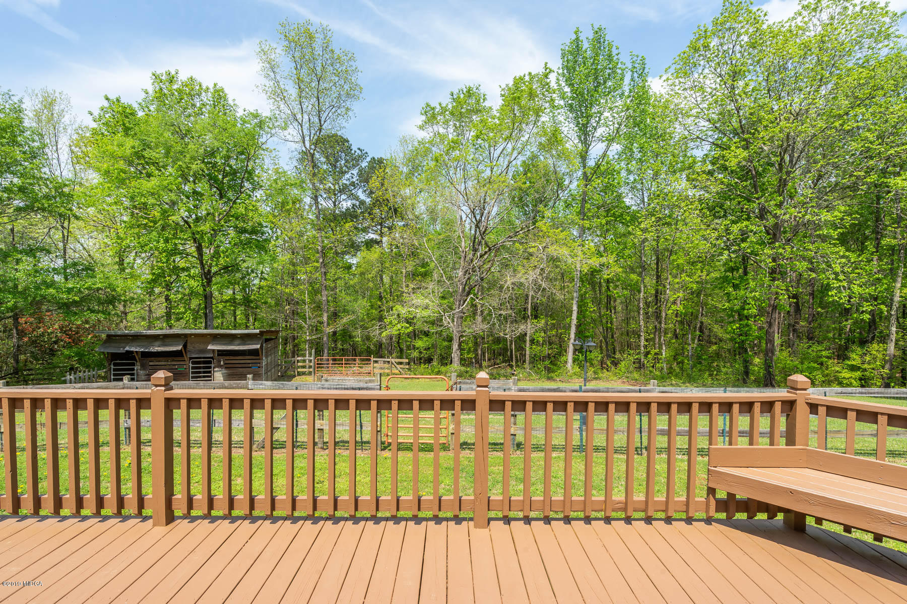 6579 New Forsyth Road Macon, GA 31210 - Photo 3 of 27 a balcony with wooden floor and fence