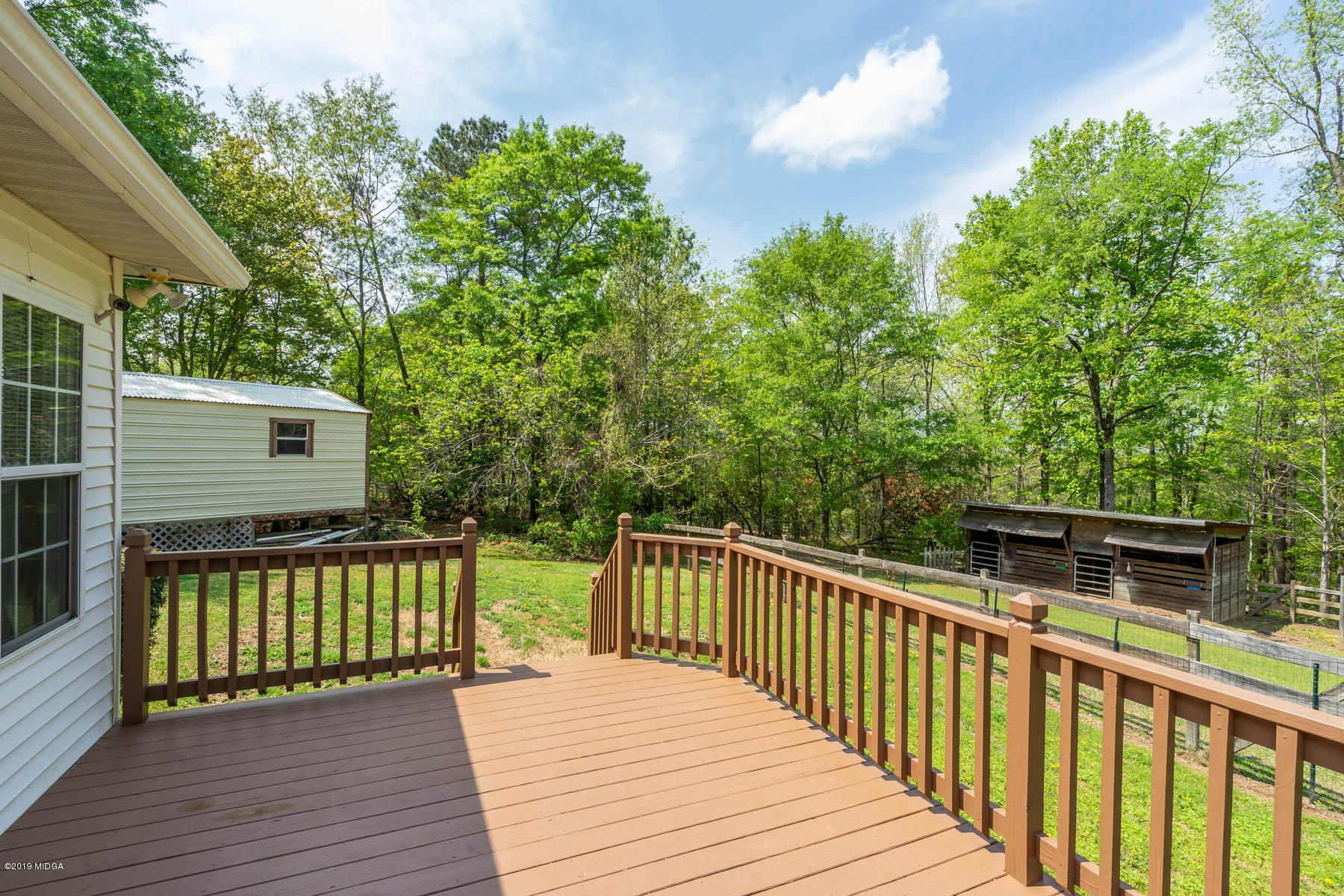 6579 New Forsyth Road Macon, GA 31210 - Photo 4 of 27 a view of a wooden deck and a yard