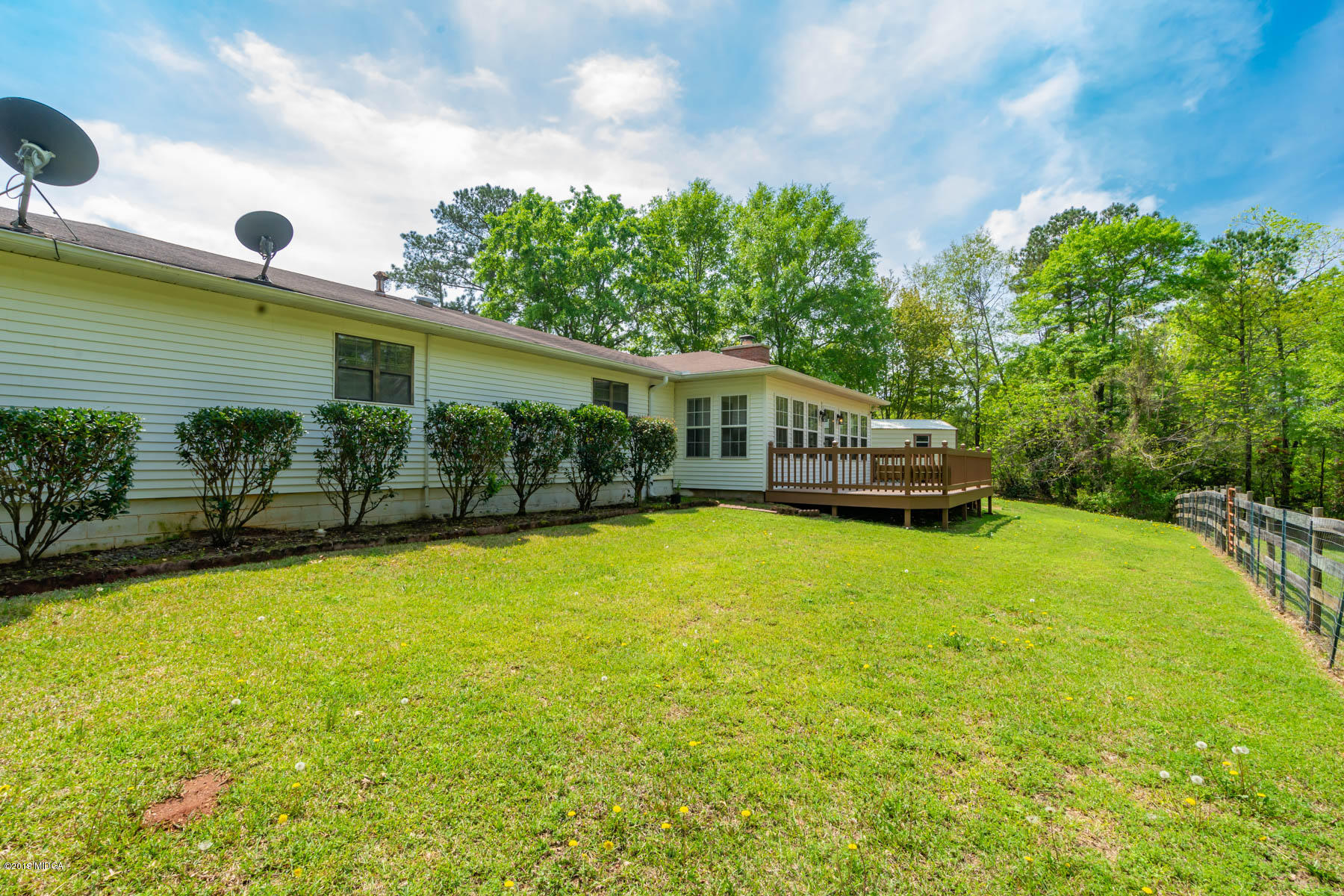 6579 New Forsyth Road Macon, GA 31210 - Photo 8 of 27 a view of a house with a backyard and a patio