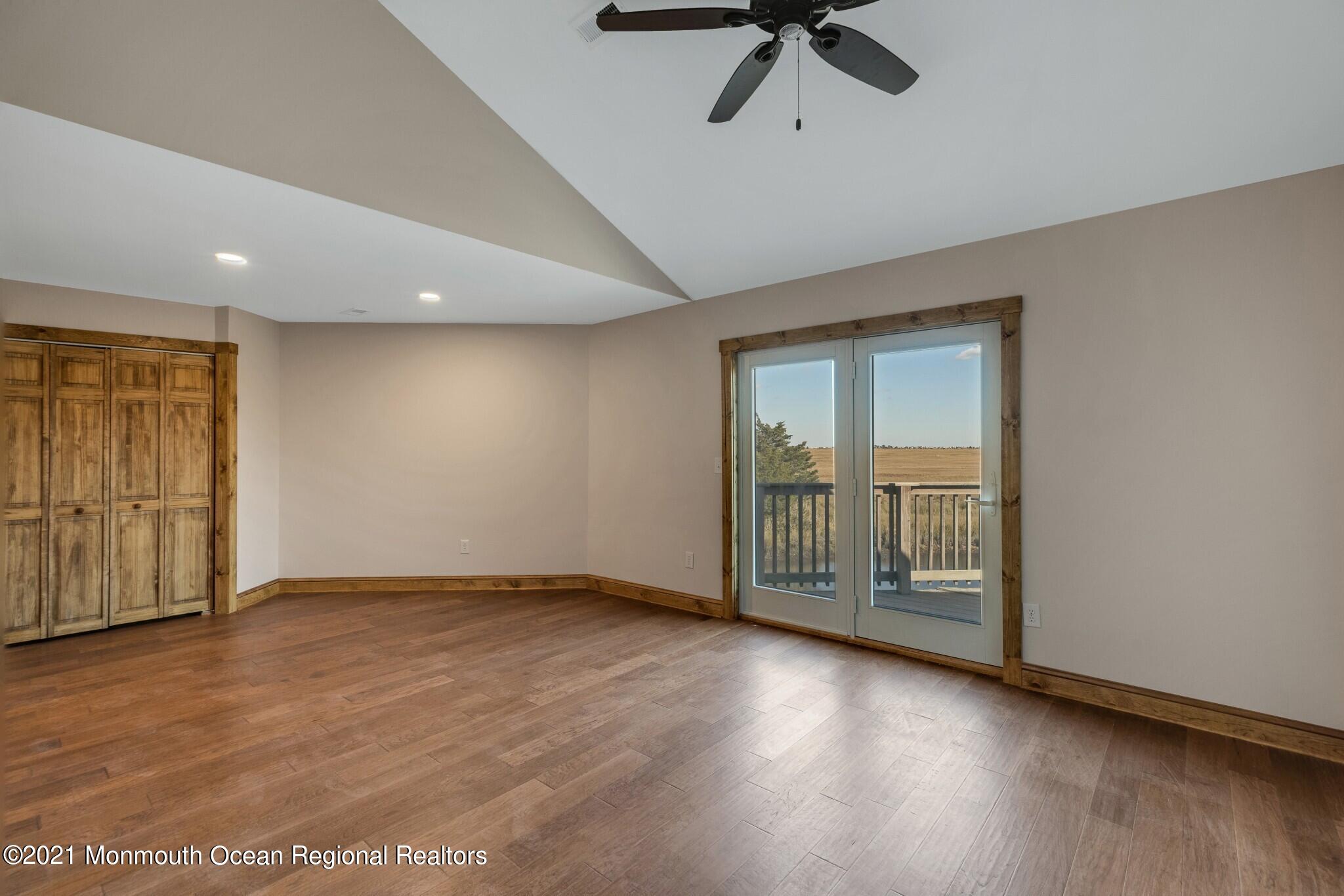 97 Edgewater Drive Tuckerton, NJ 08087 - Photo 21 of 41 an empty room with wooden floor cabinet and windows