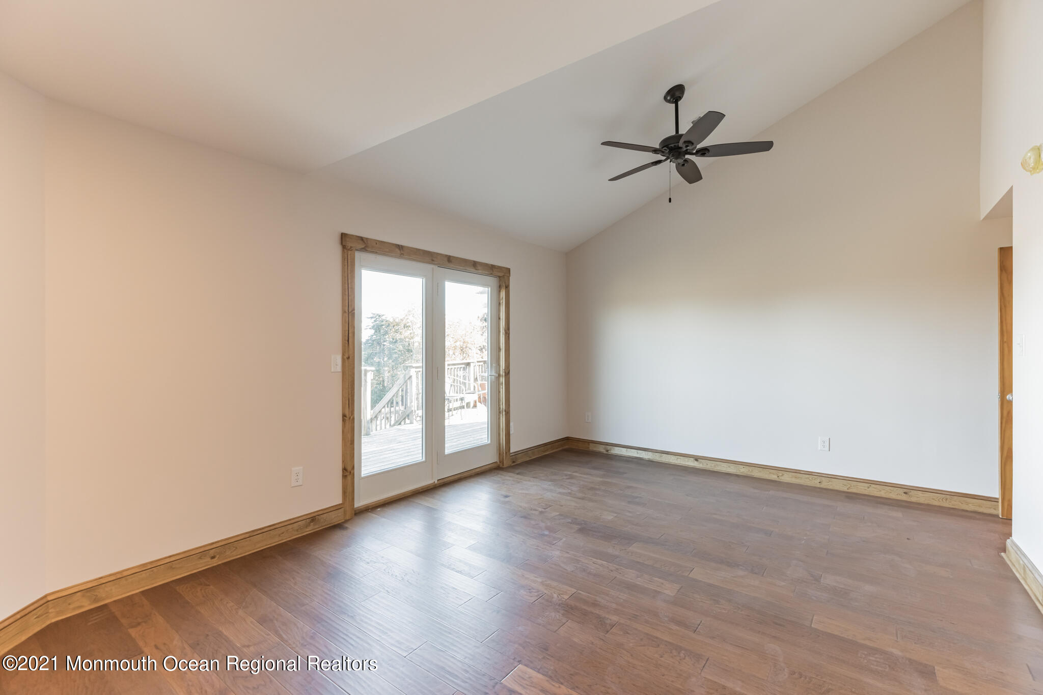 97 Edgewater Drive Tuckerton, NJ 08087 - Photo 22 of 41 an empty room with wooden floor fan and windows