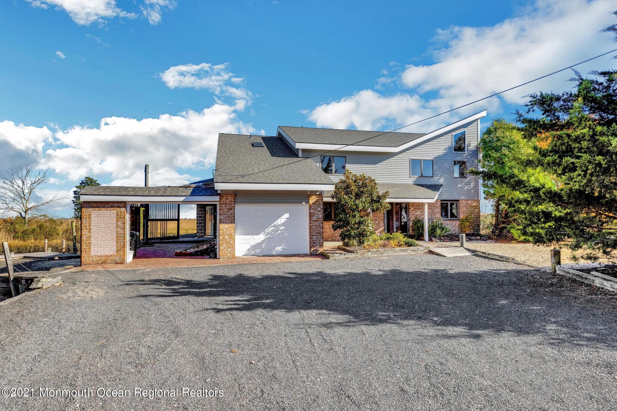 97 Edgewater Drive Tuckerton, NJ 08087 - Photo 4 of 41 a front view of a house with a yard and garage