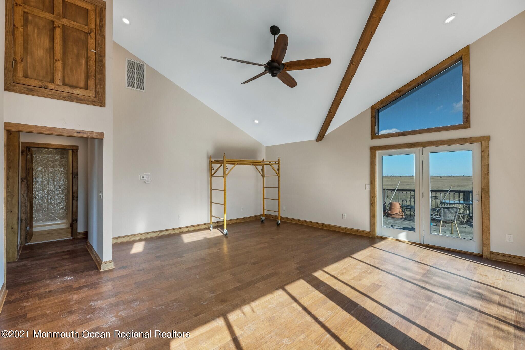 97 Edgewater Drive Tuckerton, NJ 08087 - Photo 6 of 41 a view of an empty room with wooden floor and a window