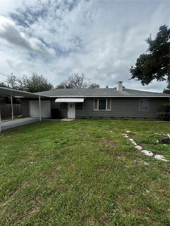 a view of a house with a garden and a yard