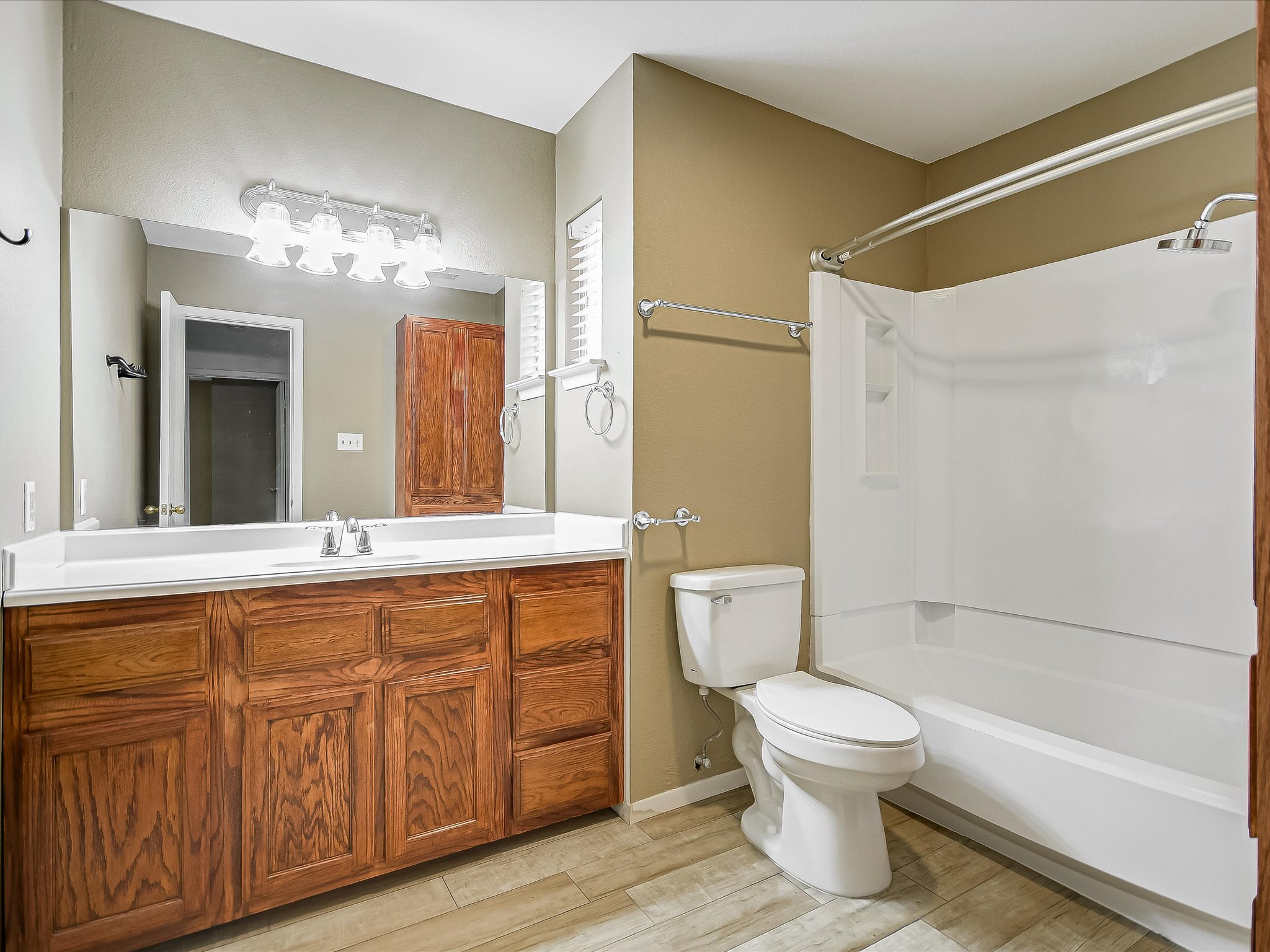 1704 Waterloo Trail, Unit B Austin, TX 78704 - Photo 6 of 10 Full bathroom with vanity, light wood-type flooring, and tub / shower combination